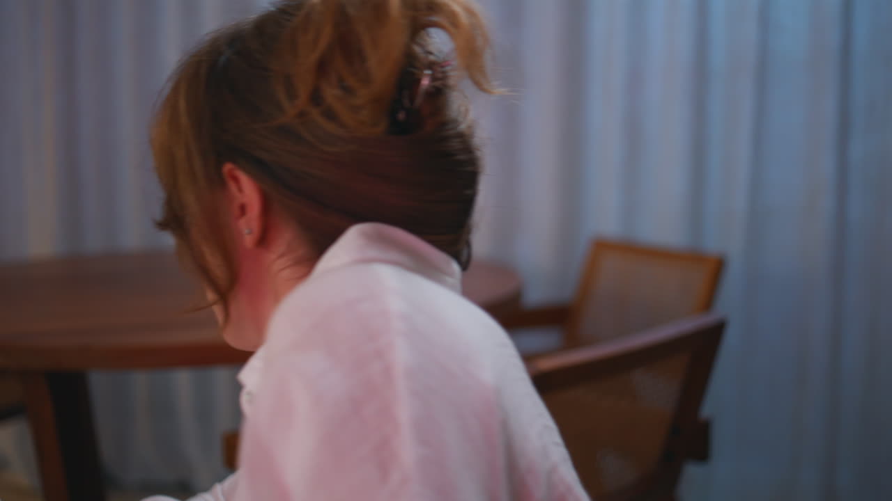 Attentive woman watching thriller at evening apartment closeup. Focused girl