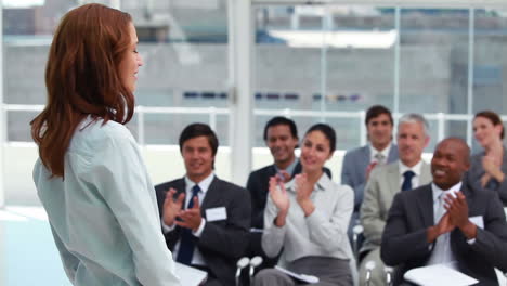 audience applauding a businesswoman