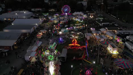 above neon lights of west virginia amusement park, funfair in usa by drone