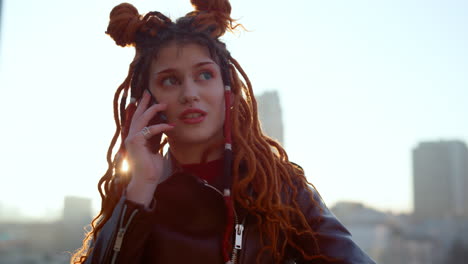 Young-ginger-woman-speaking-cellphone-outside.-Girl-using-mobile-at-rooftop.