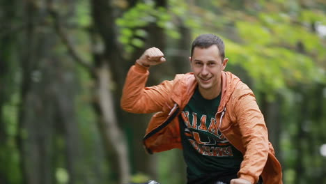 Young Couple Cycling In Park. Couple riding on bicycles and having fun in park