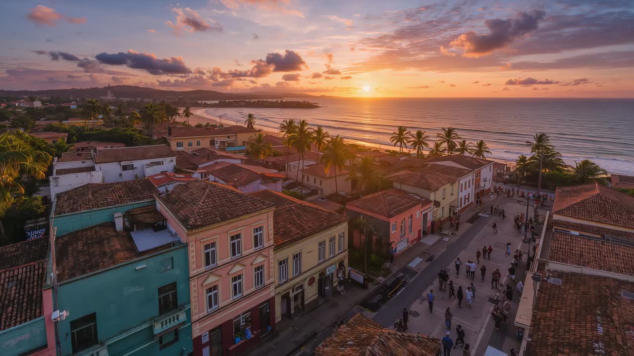 Gliding drone revealing pastel facades clay roofs palms shore as sun sinking drawing groups walking