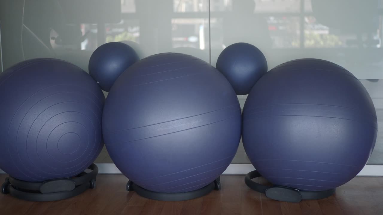 Three blue exercise balls in a gym