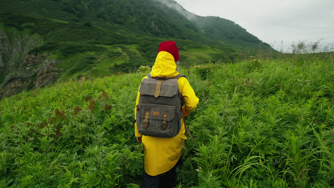 Hiking in the Mountains with a Yellow Raincoat