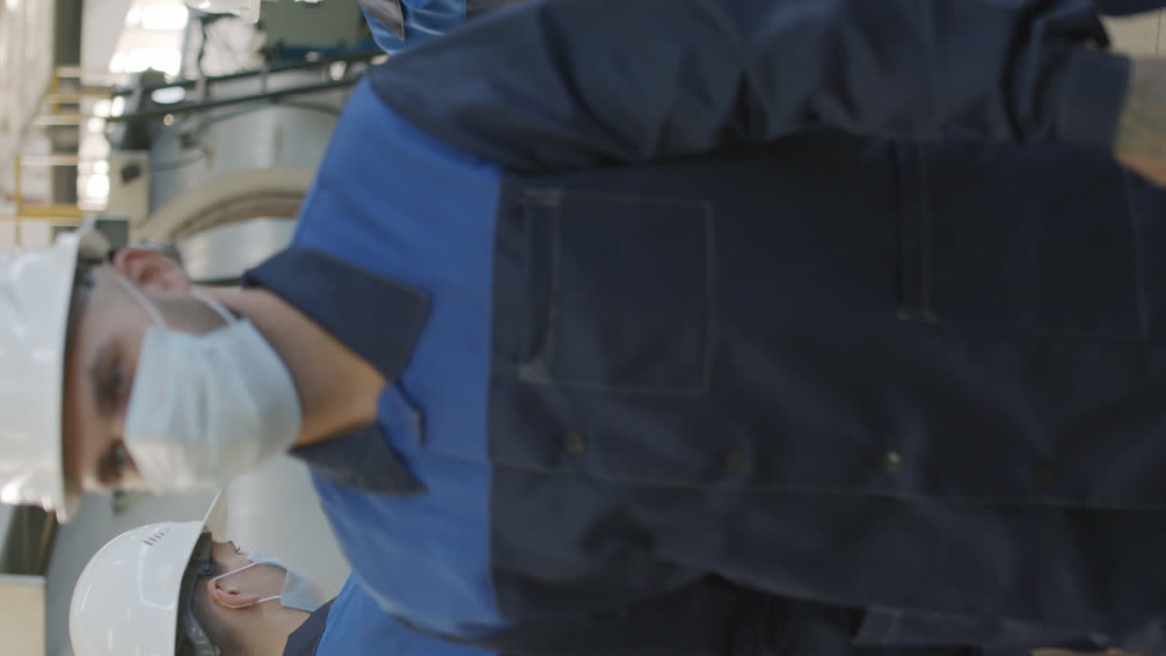 Supervisor Putting Sanitizer on Hands of Plant Workers