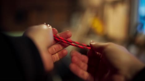 a hand tying a knot - close up