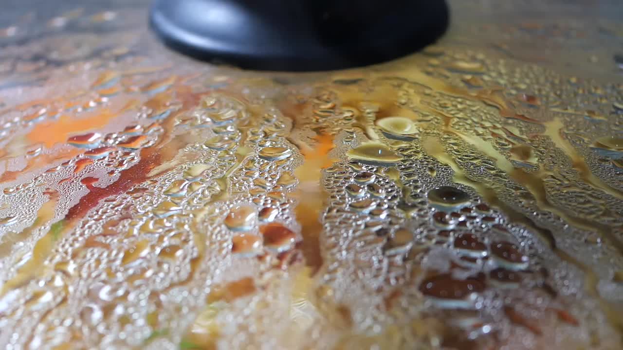 Close-up of Condensation on a Glass Pot Lid During Cooking