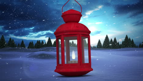 lámpara de navidad roja contra la nieve cayendo sobre varios árboles en el paisaje de invierno