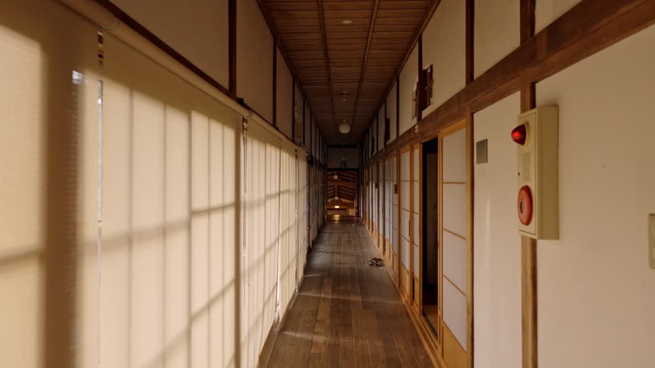 A serene and picturesque view of the traditional Japanese hallways inside a ryokan in Koyasan, Japan.