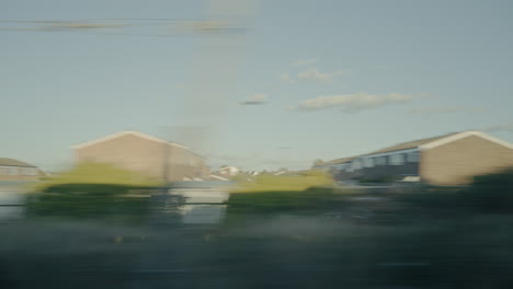 looking out a train window at the British countryside