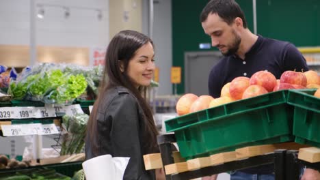 customers shopping for fruits and vegetables in a grocery store