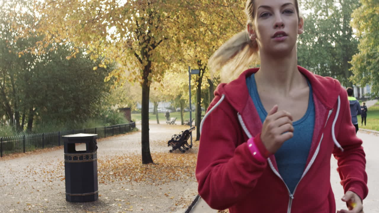 Runner woman running in park exercising outdoors