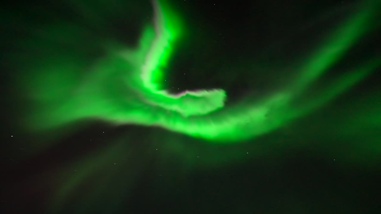 Real-time footage of vibrant green Aurora Borealis dancing in night sky, Norway