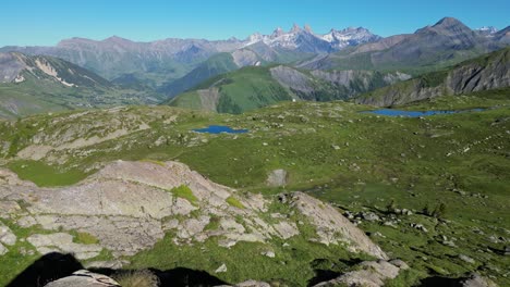 Young-Adult-Woman-walks-to-Panoramic-viewpoint-in-French-Alps---Aerial