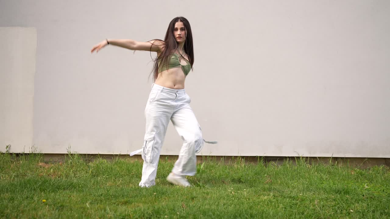 Woman dancing outdoors in grass