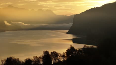 golden hour sunset over a calm lake and majestic mountains
