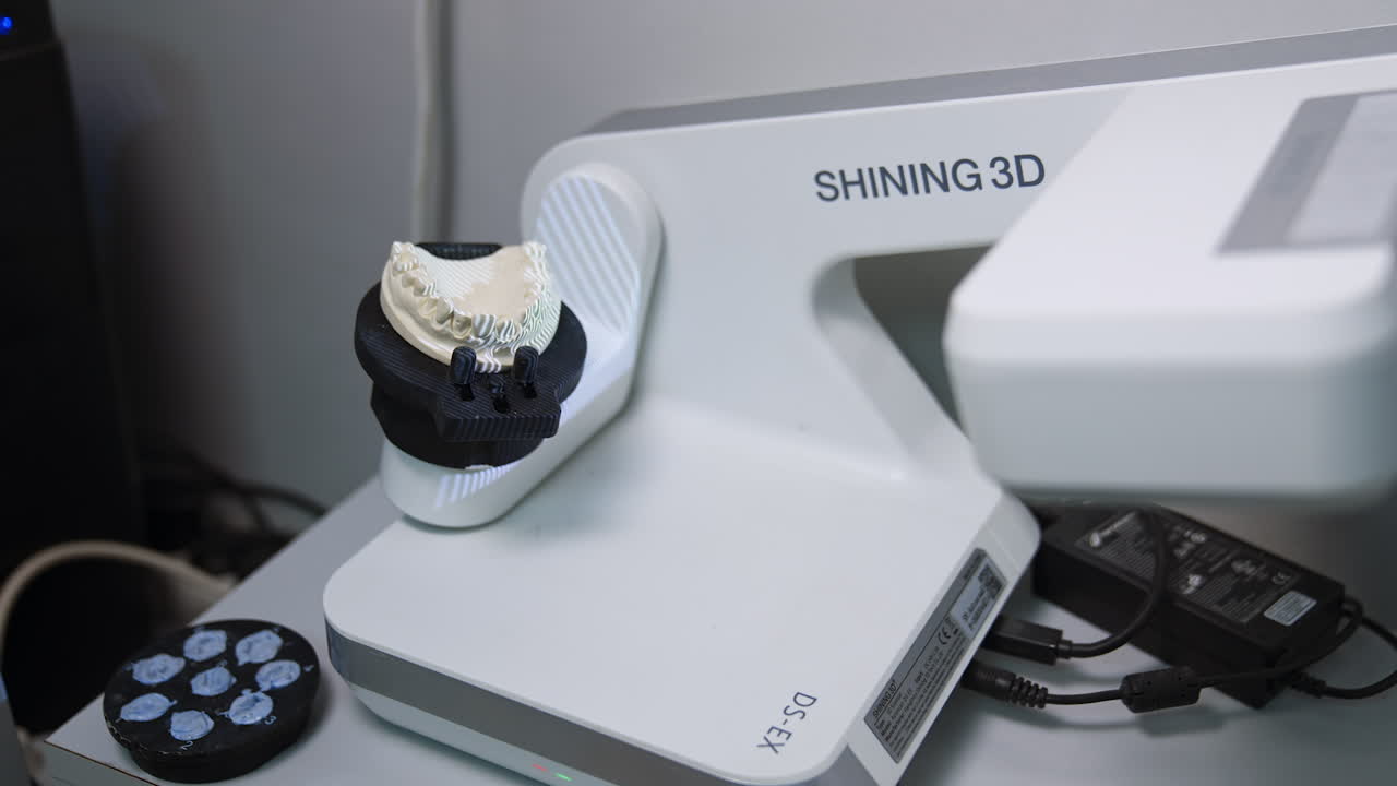 Plaster denture rotated on the dental lab scanner. Production of dental ceramic implants.