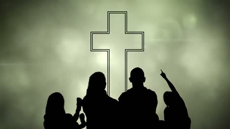 animation of silhouette of christian cross and a family over glowing green clouds