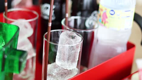 ice cubes added to glasses for refreshing drinks