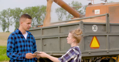 young farmers discussing at wheat field 18