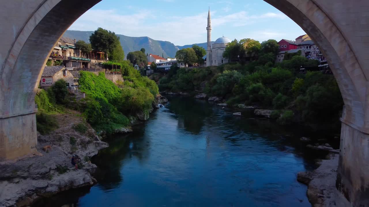 4K Drone video reversing to reveal incredible Old Ottoman and stone Mostar Bridge over Neretva River - Bosnia and Herzegovina