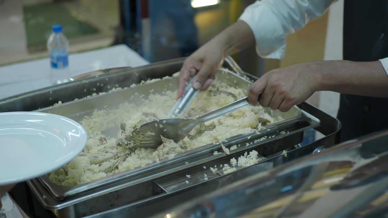 Chef serving hot rice dish at a buffet