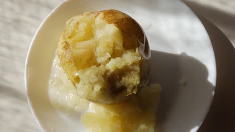 eaten baked potato on a white plate