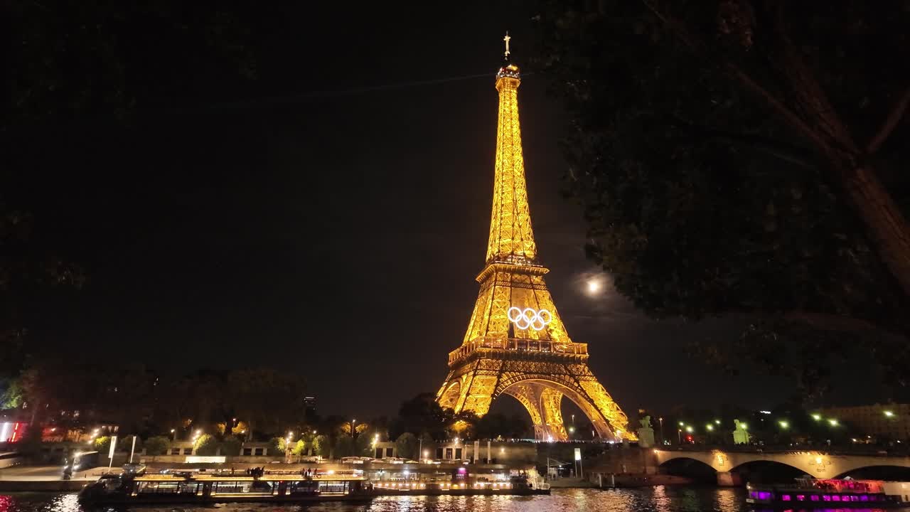 Eiffel tower Olympic rings at night Paris France light up, tourist landmark