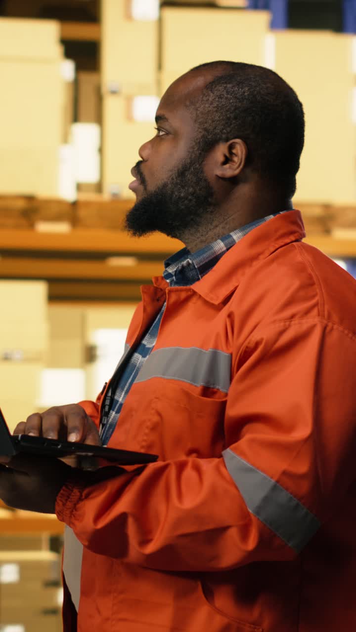 Vertical Video African American Employee Using Laptop To Handle Logistics In Industrial Facility
