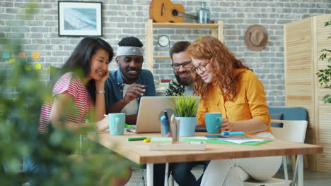 group of diverse friends collaborating on a laptop