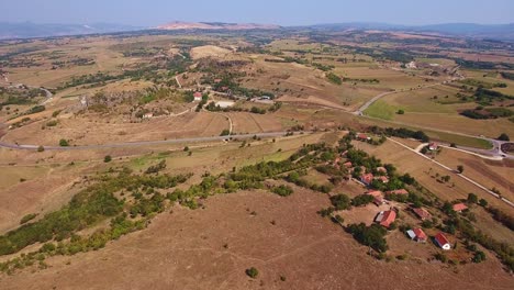 hilly landscape with roads, cars traveling