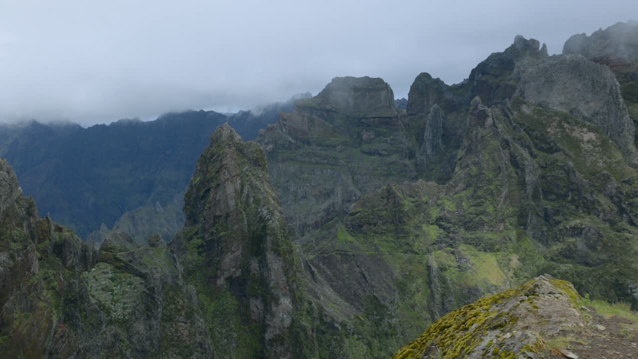 Peaks of Pico do Arieiro, Madeira, rugged landscape shrouded in clouds and fog, Portugal. Zoom in