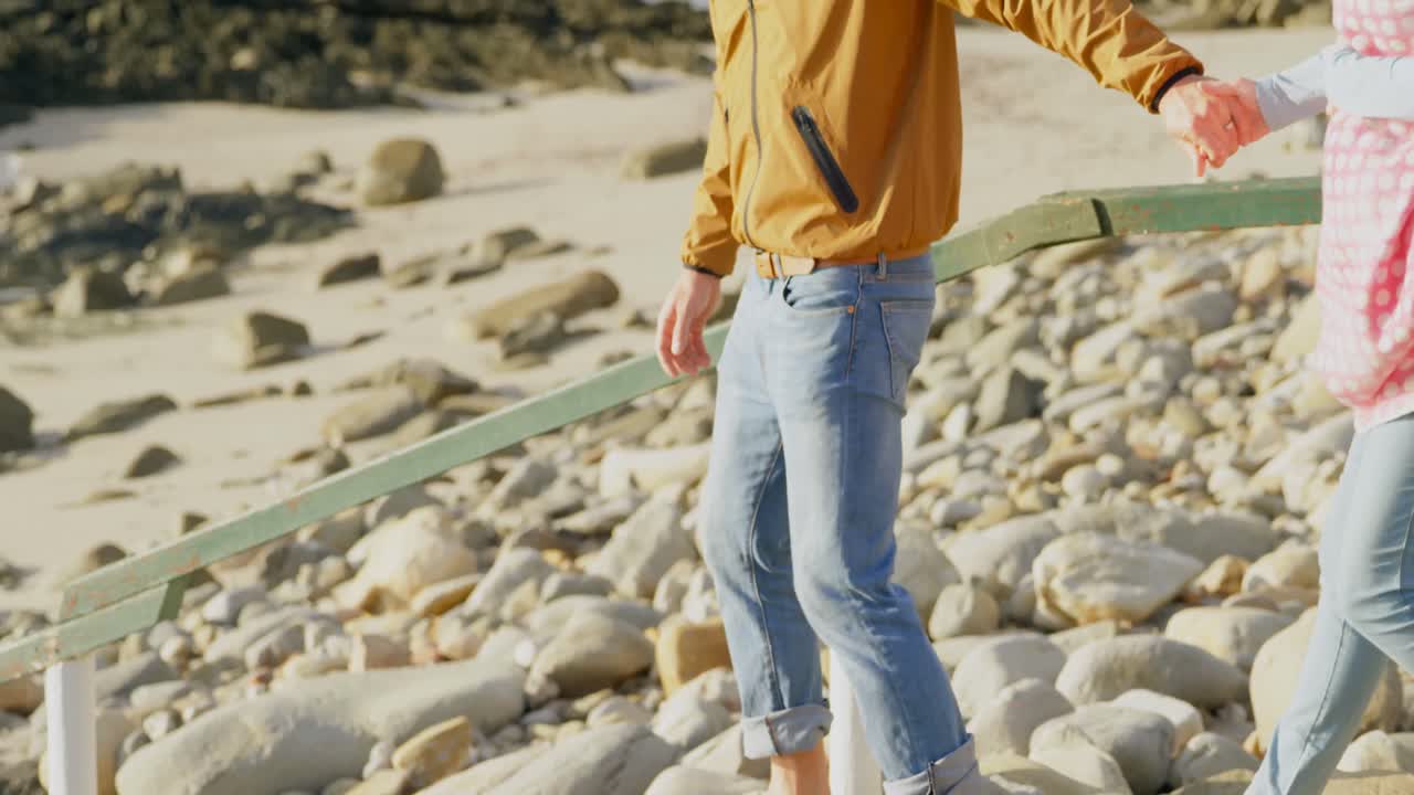 晴れた日にビーチで歩いている白人家族のサイドビュー 4k