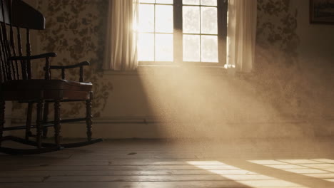vintage rocking chair in dusty room with sunlight