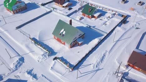 aerial view of snowy village with houses