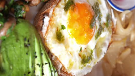 fried egg and avocado toast with pesto