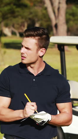 Golfer writing on paper