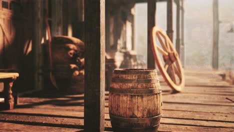 a wooden barrel sitting on a porch in a western saloon