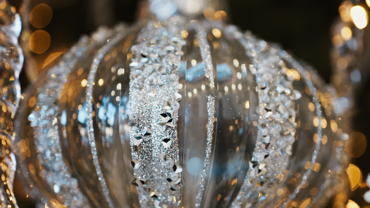 Close up of a globe decoration on a lighted Christmas tree