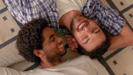 happy homosexual couple lying on the floor
