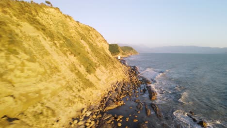 Fast-fly-over-waves-crashing-on-rocks,-coast-of-Vlora,-Albania