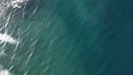 Aerial-View-of-Blue-Ocean-Waves-crashing-on-reef-and-sandy-beach-in-Bidart,-French-Basque-Country-close-to-Biarritz