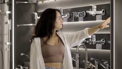 woman shopping for bathroom faucets in a showroom