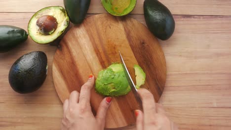 slicing avocados on a wooden cutting board