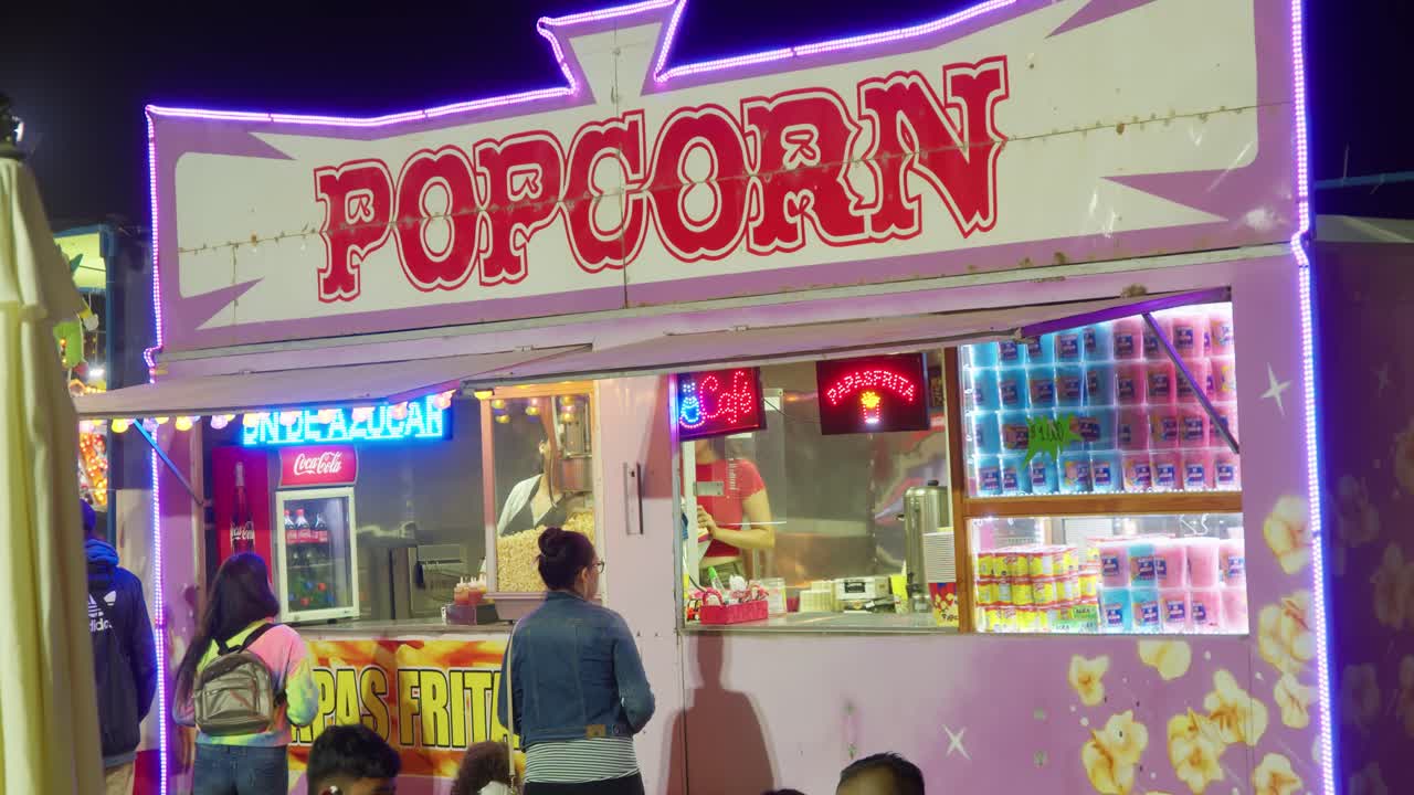 Customers ordering at a popcorn food truck in slow motion