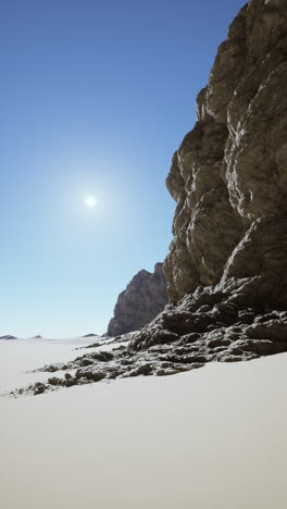 a solitary cliff rises in the vast desert landscape.