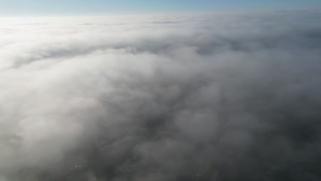 beautiful drone footage over. the top of fog in the uk