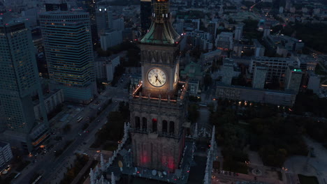 Ascending-elevated-footage-of-top-tower-on-tall-historic-building-in-Russian-style.-City-centre-at-dusk.--Warsaw,-Poland