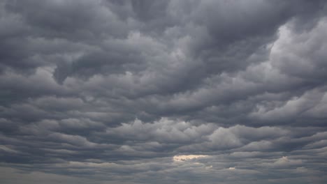 dramatic video of overcast sky with thick, layered clouds. captured from a low angle