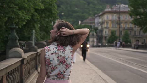 woman walking in prague city and turning to camera, optimistic smile, pretty face closeup view